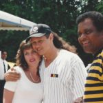 Neal McCoy hugs a female fan for a photograph while Charley Pride smiles