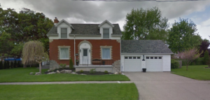Our new place - brick front with a two car garage, two storey home. Has steel roof and dormers on the front 