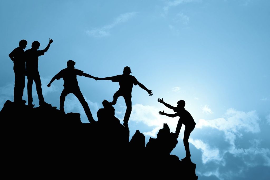 twilight - friends helping each other up a hill
