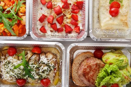 various dinners - chicken burger, salad etc. - in delivery cartons