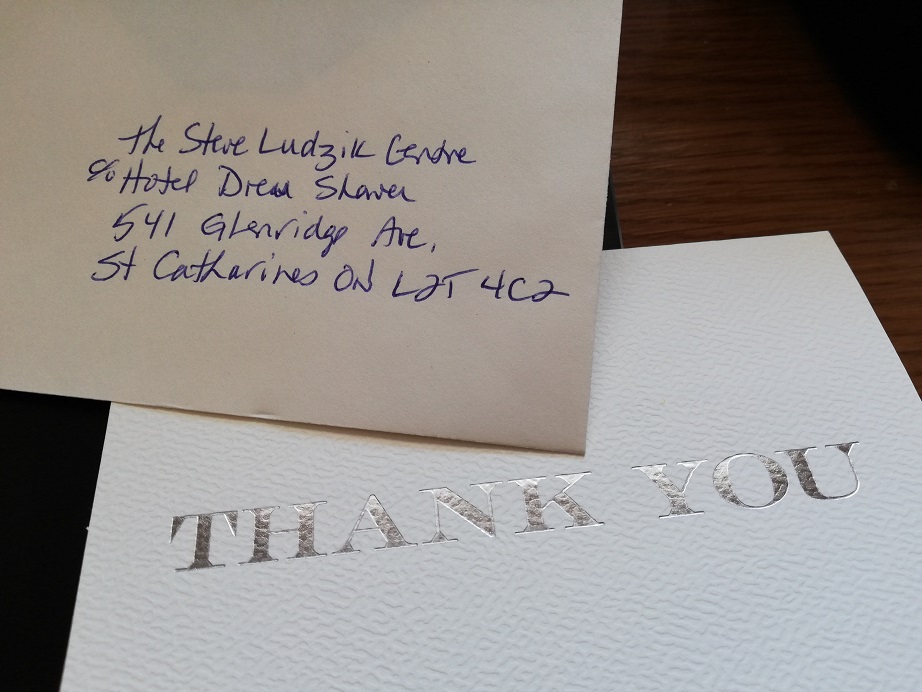 Front of a thank-you card and the envelope addressed to the Steve Ludzik Centre. 
