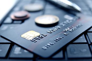 credit card with coins on top of it