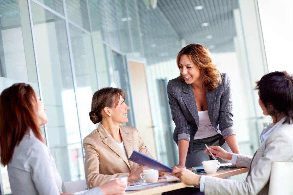 Two women talking in a modern boardroom