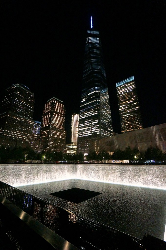 The September 11 memorial in NYC lit up at night