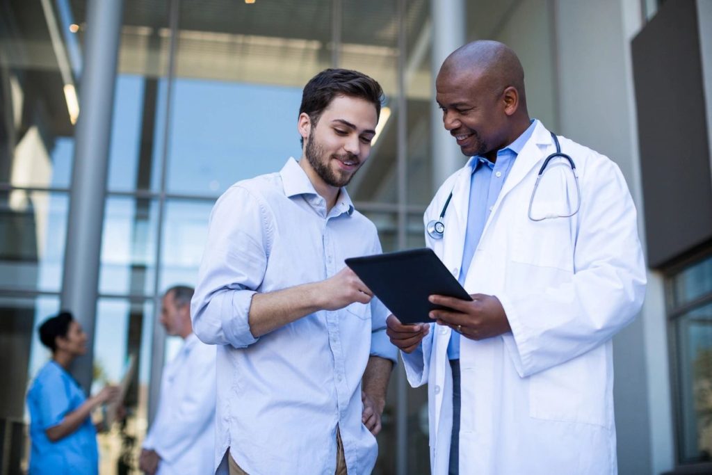 two young happy doctors consulting on a file