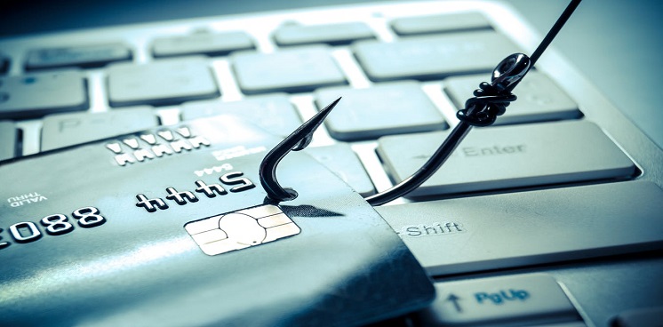 computer keyboard with a credit card hooked on a fishing hook