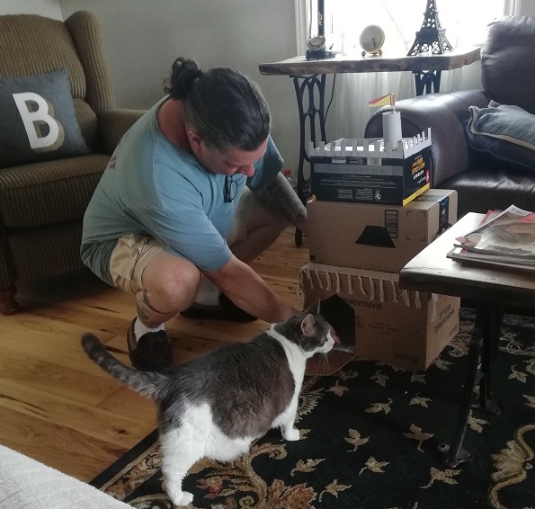 Derek on the floor, trying to convince Miss Sugar to enter the castle, while she looks away. 