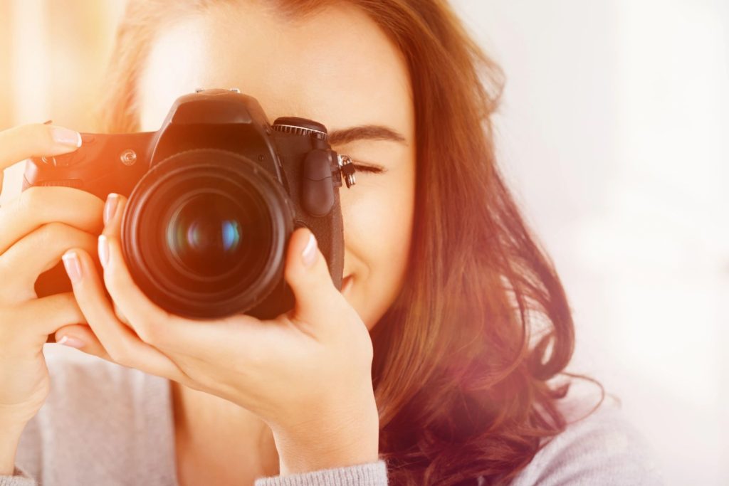 closeup looking toward a woman who's holding a camera and about to take a photo