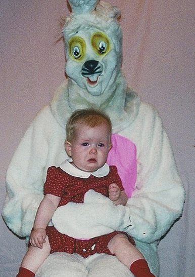 Awful bunny masked-man holds crying baby. 