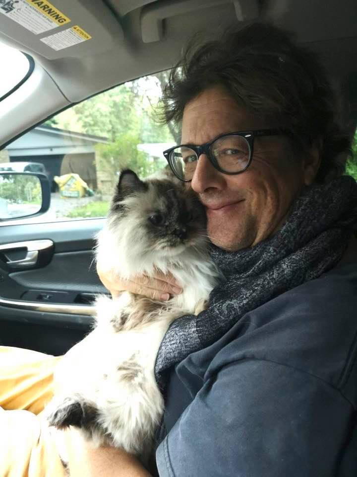 Louis holds his beloved cat Cou Cou in the car before her first road trip.