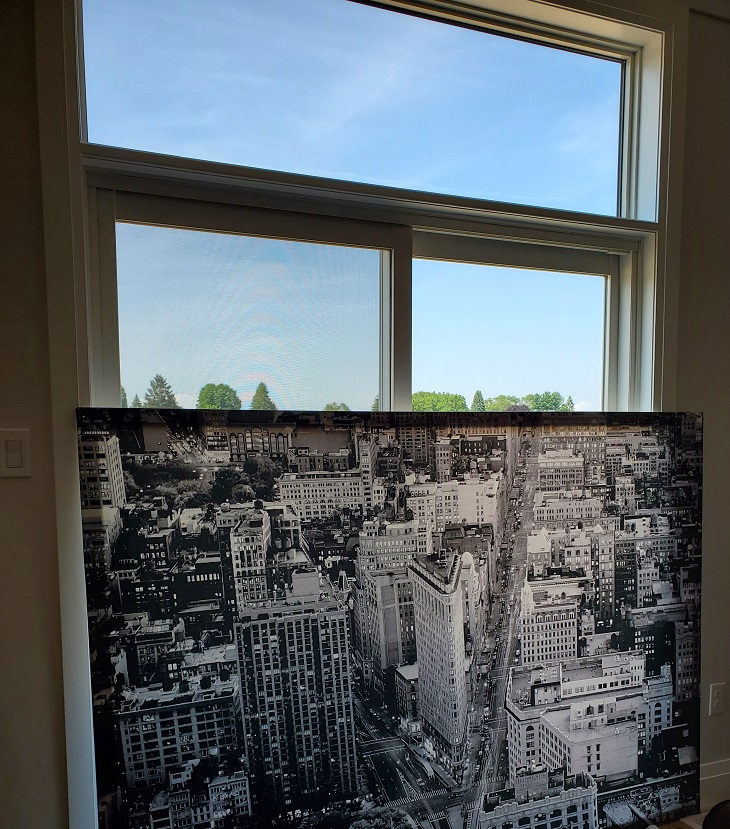 Black and white canvas of New York with the flat-iron building in the middle, covering most of a patio door window.