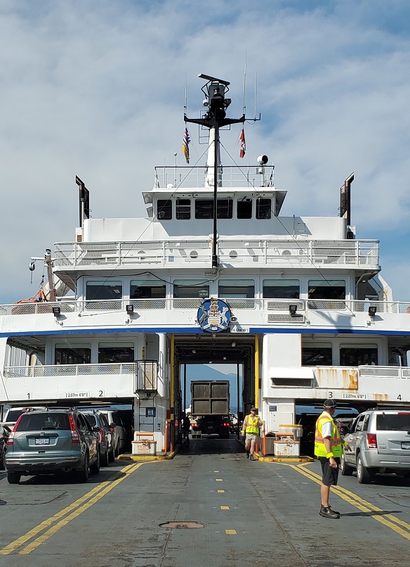 Front of a BC ferry with cards driving on board. 