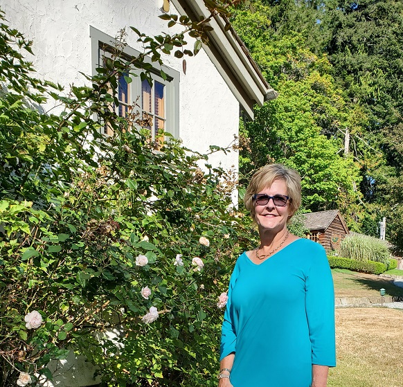 Erin last year beside a beautiful bush with large white flowers