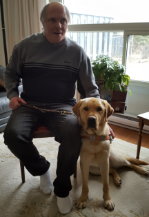 Allan sitting on a stool and Rusty sitting beside him. 