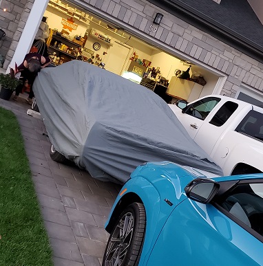 Convertible shrouded in a grey cover.