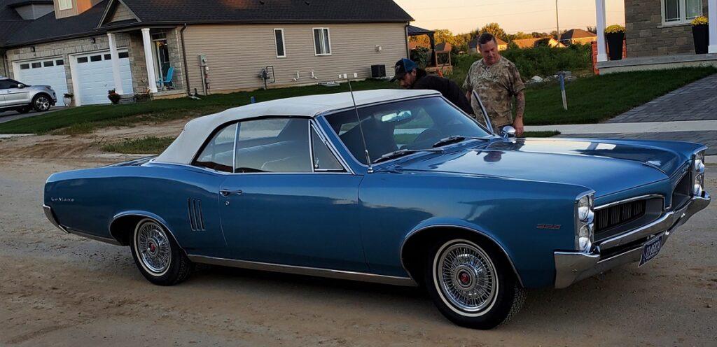 blue Le Mans convertible with a white ragtop. A huge car compared to today's models