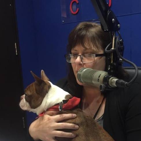 me in front of a microphone with a cute dog on my lap