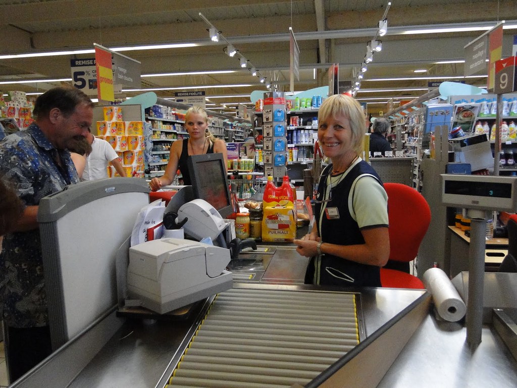 grocery cashier and customers at the till