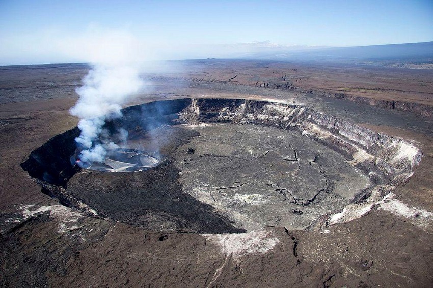 The Halemaumau crater. A large circular indentation in the earth whose base is cracking due to dryness. 