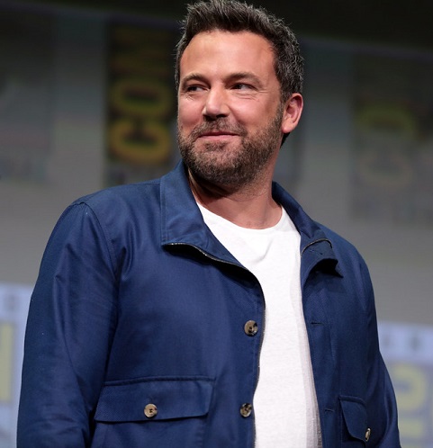 Ben Affleck smiling at something to the right of the camera. 
