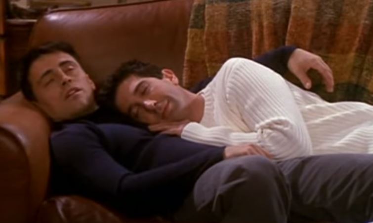 Joey and Ross on Friends are cuddled on a couch napping