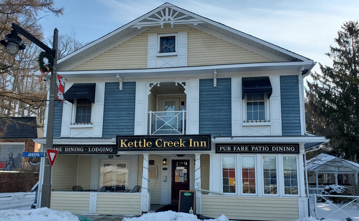 Large blue and yellow former mansion with white trim: Kettle Creek Inn