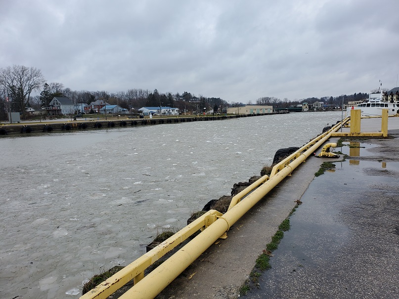 The harbour is frozen over with obvious chunks of ice - it's not smooth.