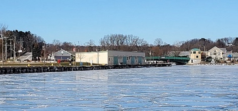 A view into the harbour from the lake point of view, with the long, green Dominion of Canada building on the left side