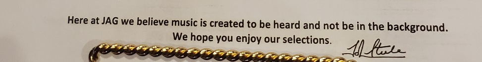 Text from the menu reads, "Here at Jag we believe music is created to be heard and not be in the background. We hope you enjoy our selections. Signed by John Steele.