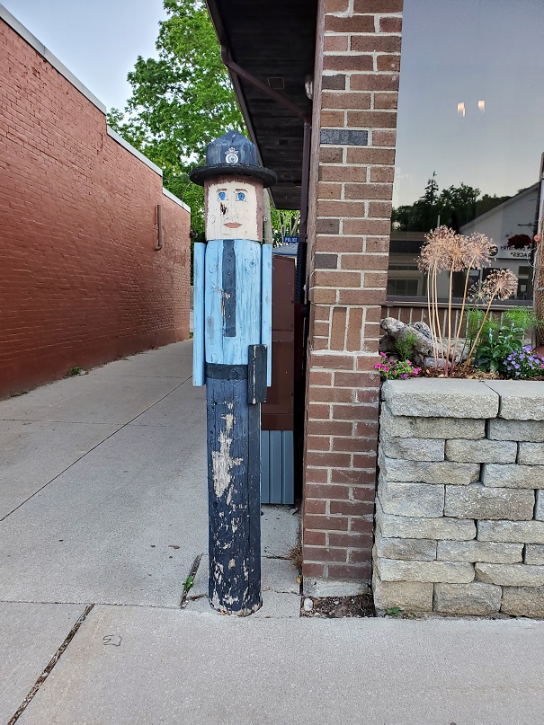 A closeup of the wooden officer shows he has some peeling paint and a few wounds but love in his heart.