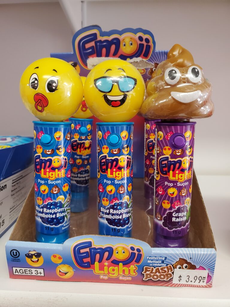 A box of little flashlights with emoji shapes on top and candy in the handle. A baby, a cool face with sunglasses, and the poop are in the front row.