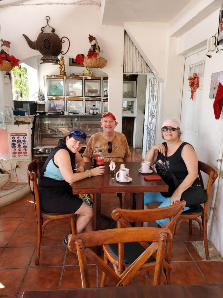 Laurie, Jeff and me at our seats in the roadside taco eatery. It's a little run down but clean. Wooden tables and chairs, terra cotta tile flooring. White walls.
