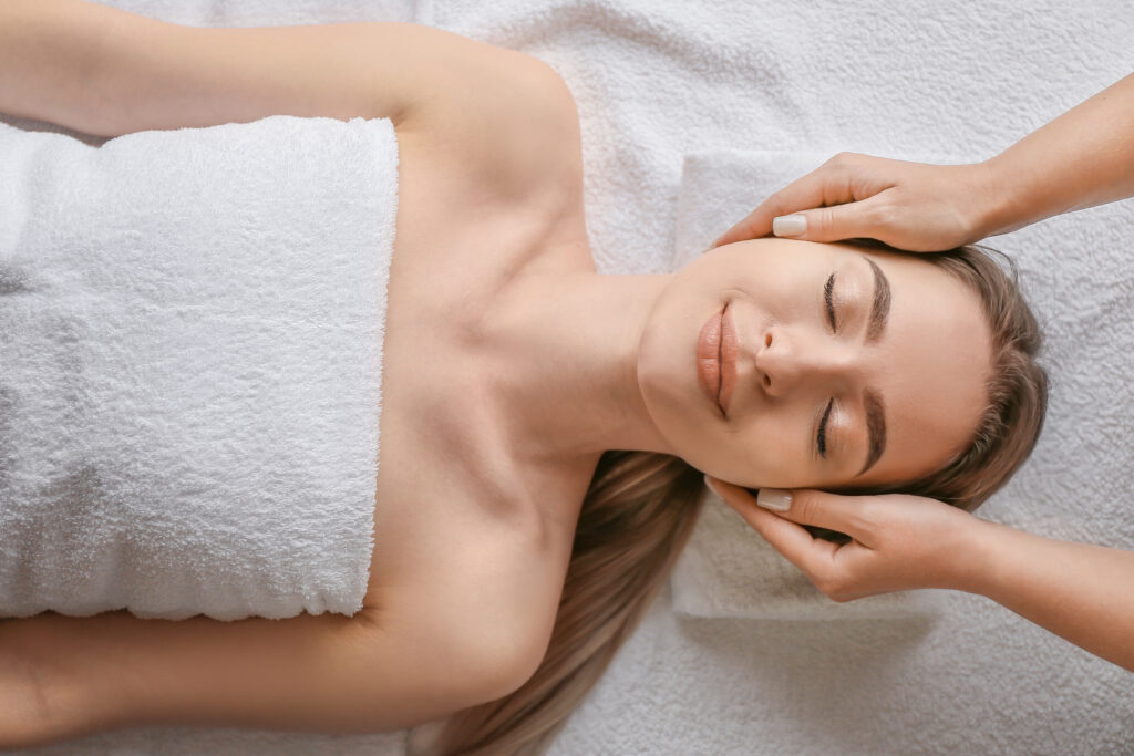 Woman lying on her back with hands cupping either side of her head. From Stock Snap