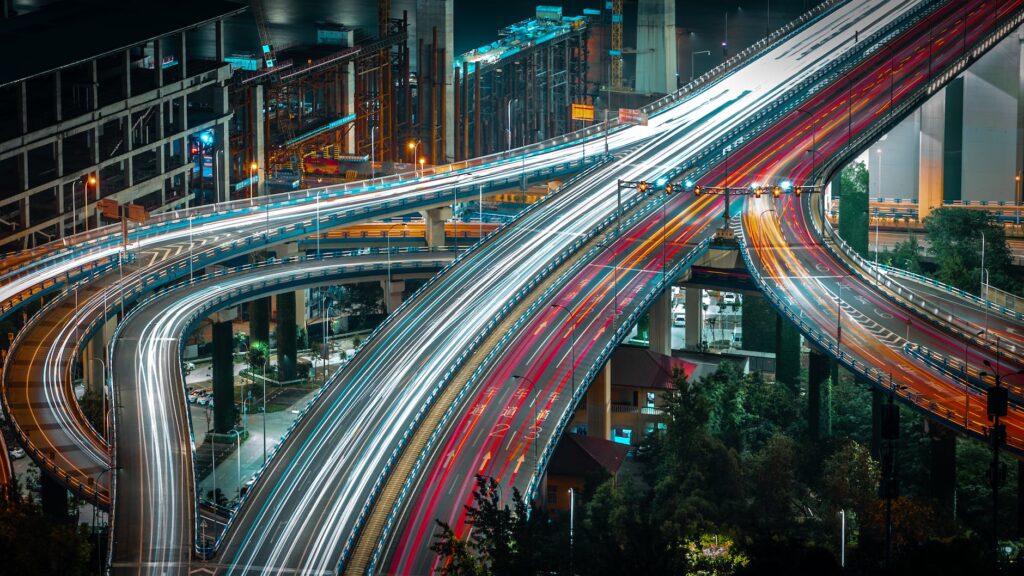 cars driving on urban highway in evening