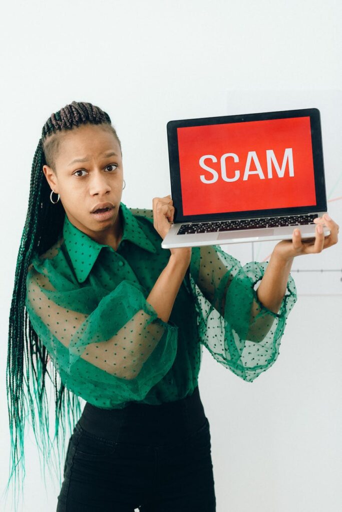 a shocked woman holding a laptop