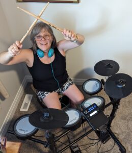 I'm sitting behind my new electric drum kit with the sticks in the air like I'm counting down to a song