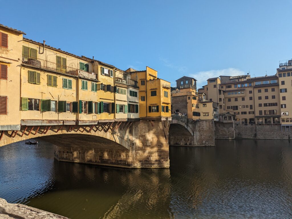 Ponte Vecchio in Florence, a stone bridge that has shops on and around it. 