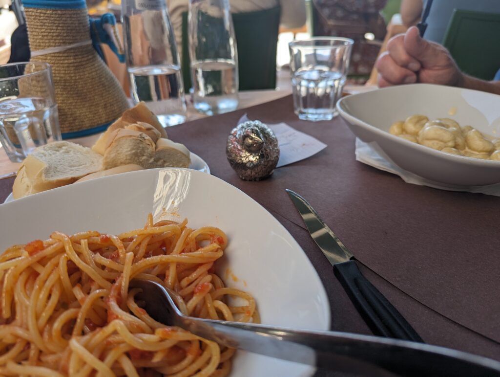 Our table in Venice with a basket of bread, my spaghetti in plain tomato sauce and Derek's gnocchi carbonara. 