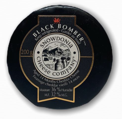 A round, black, cheese with the name, Snowdonia, Black Bomber, on a label on the front.