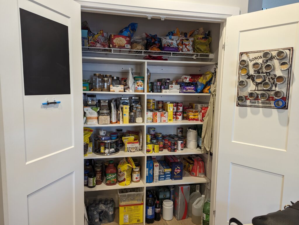 The finished pantry has five built-in shelves that span the width and are deeper. With everything organized, there's a lot more space now. 