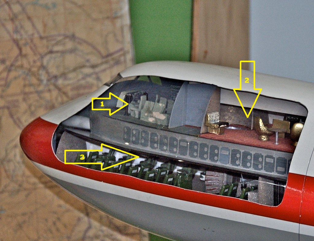 A cutaway model of one of these 747s shows the cockpit up top with a lounge and bar behind it. On the lower deck is eight rows of first class seating and the spiral staircase behind it.
