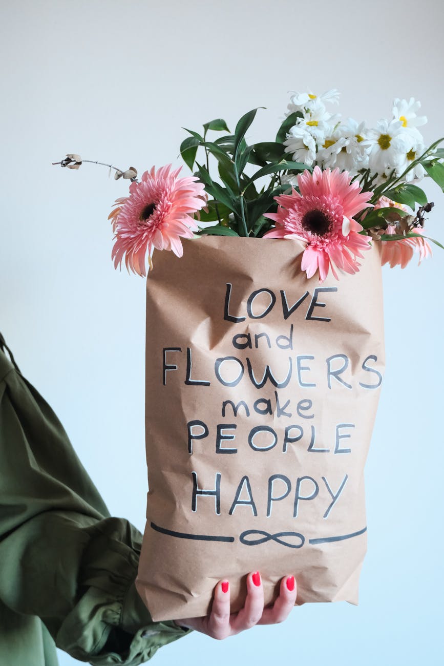 woman hand holding bag of flowers