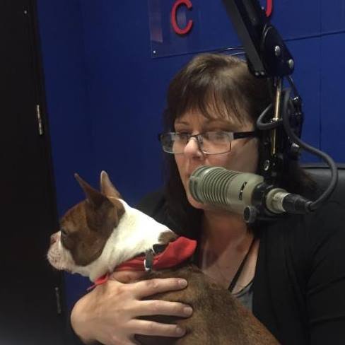 Reading the news on air at CJBK with a visiting dog on my lap.