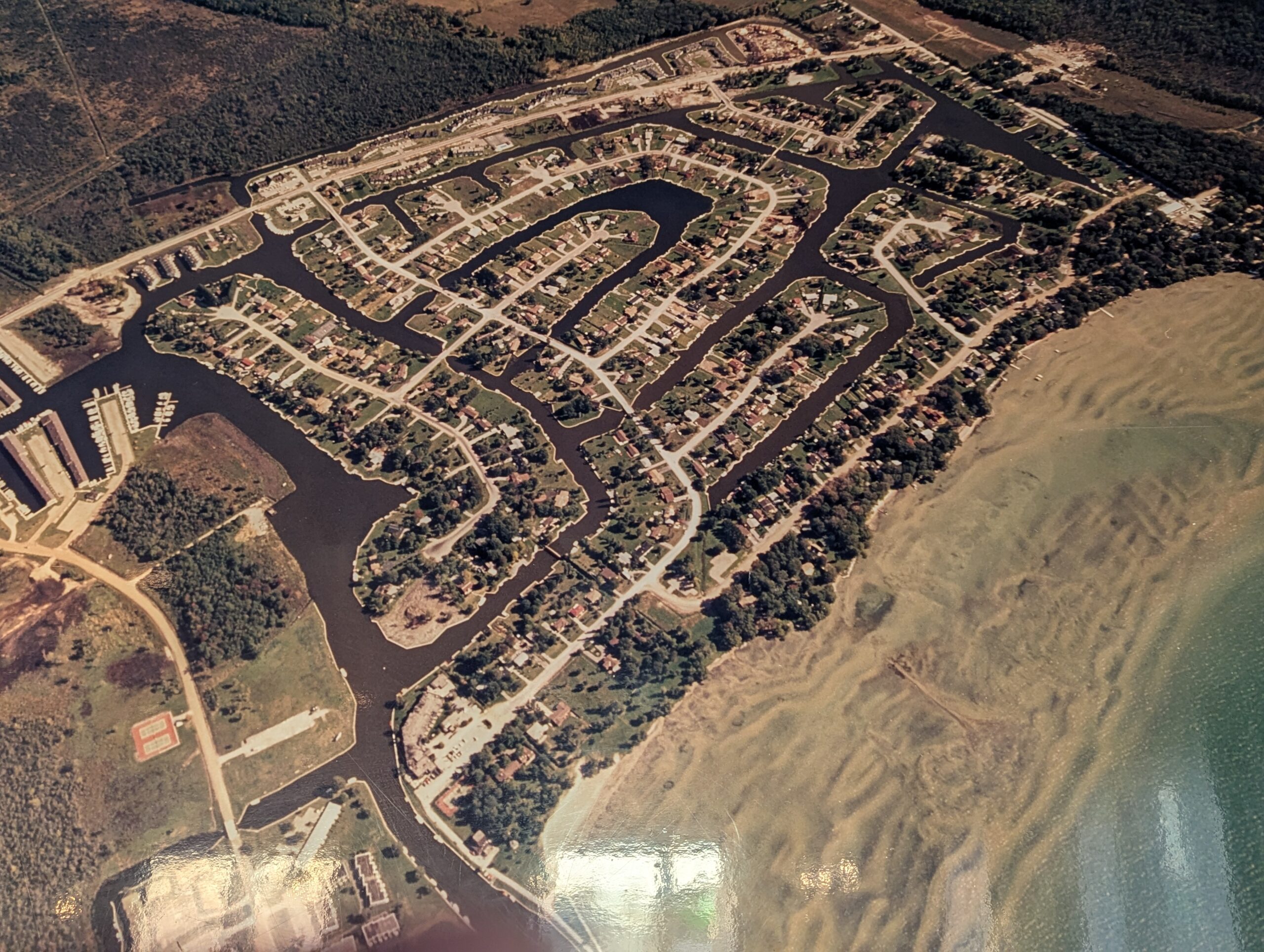 Large map of Lagoon City shows canals weaving in and out of the area, the access to Lake Simcoe, and the sand bars in front of two large private beaches