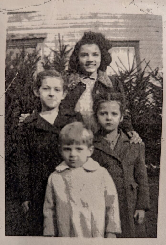 A picture of a picture of my Mom and her siblings. Aunt Wanda as a teenager, my Mom (maybe 11 or 12), Aunt Ann, and Uncle Caz.