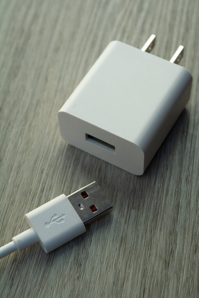 close up of white usb charger and cable