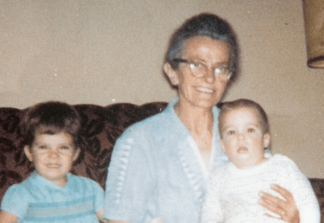 A 1960s era photo of a tiny old woman with Kevin as a baby on her lap and me as a toddler sitting beside her
