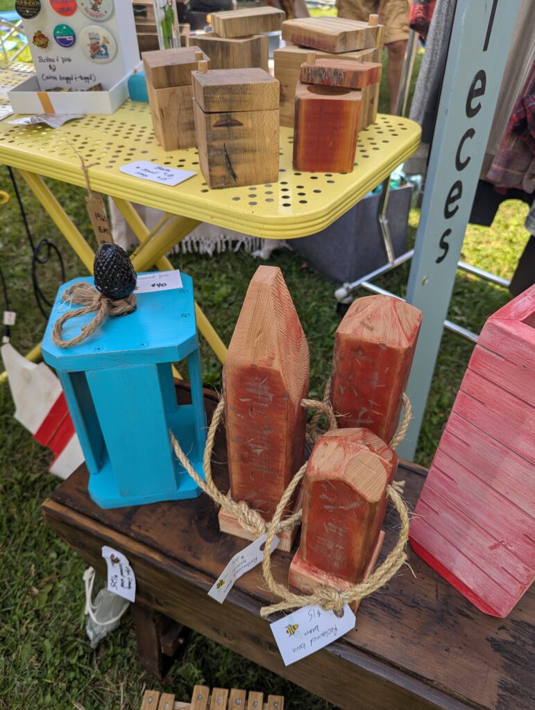 A close up of some things including wooden lanterns, boxes, nautical decor, and more. 