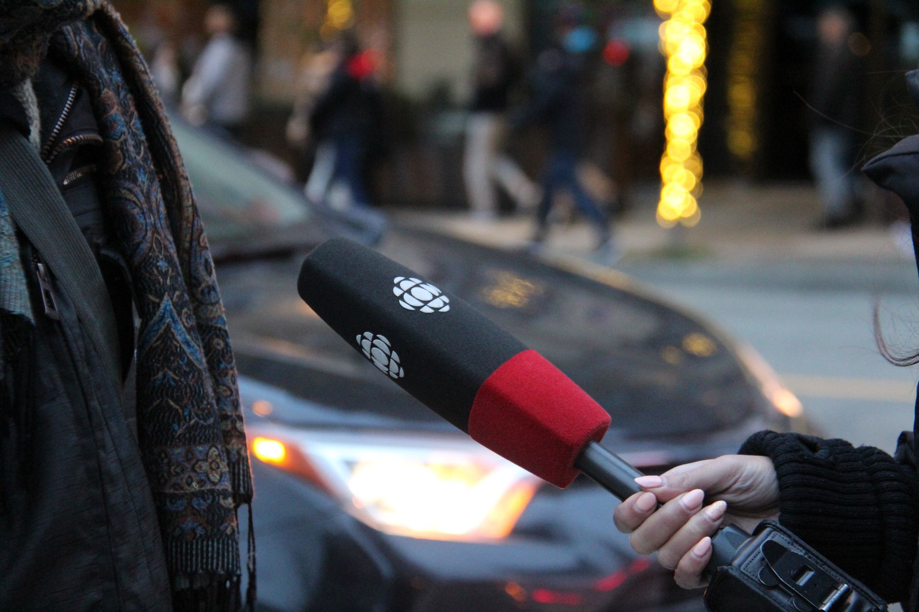 person speaking and holding microphone