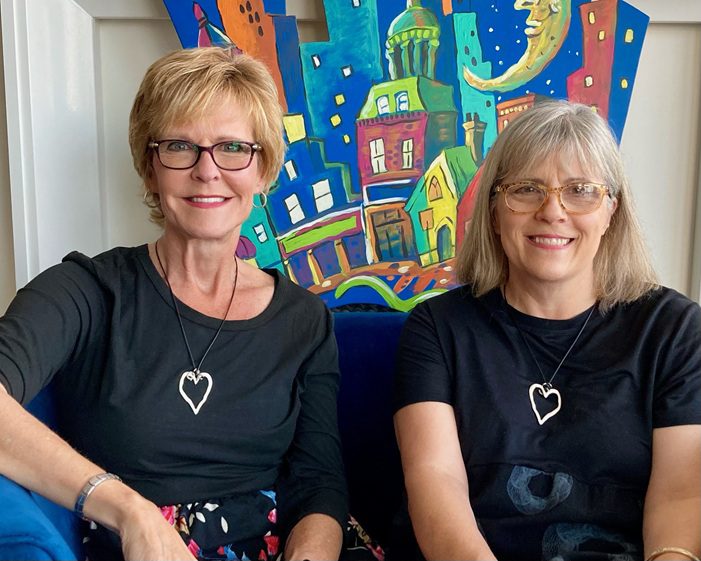 Erin and me in front of a colourful print before doing a facebook live show